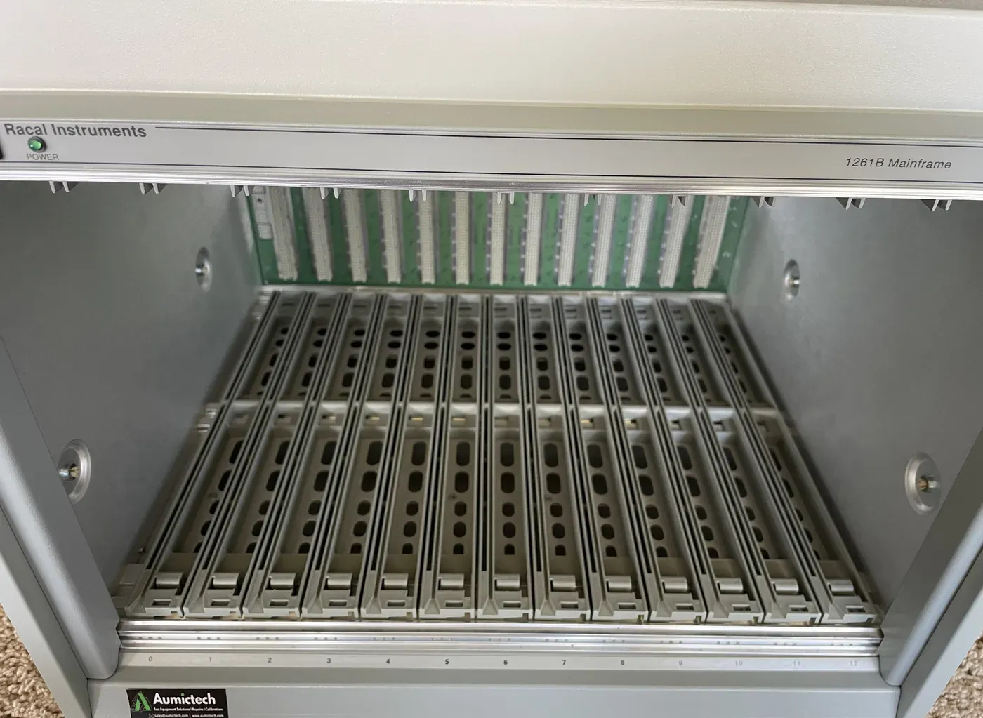Inside a Racal 1261B VXI mainframe showing the molded card guides that direct cooling airflow through installed C-size modules